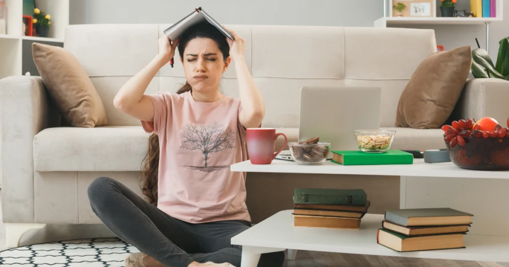 Woman feeling stressed and overwhelmed by overthinking while studying at home